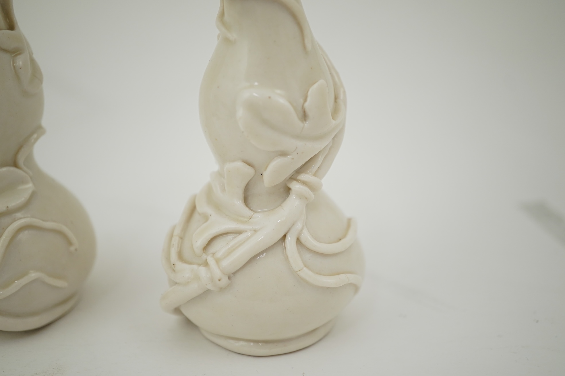 A pair of Chinese blanc-de-chine gourd-shaped vases, Dehua kilns, Qing dynasty